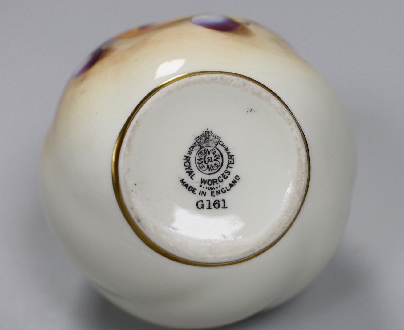 A Royal Worcester spirally moulded globular vase painted with fruits by Roberts, date code for 1955, height 7cm